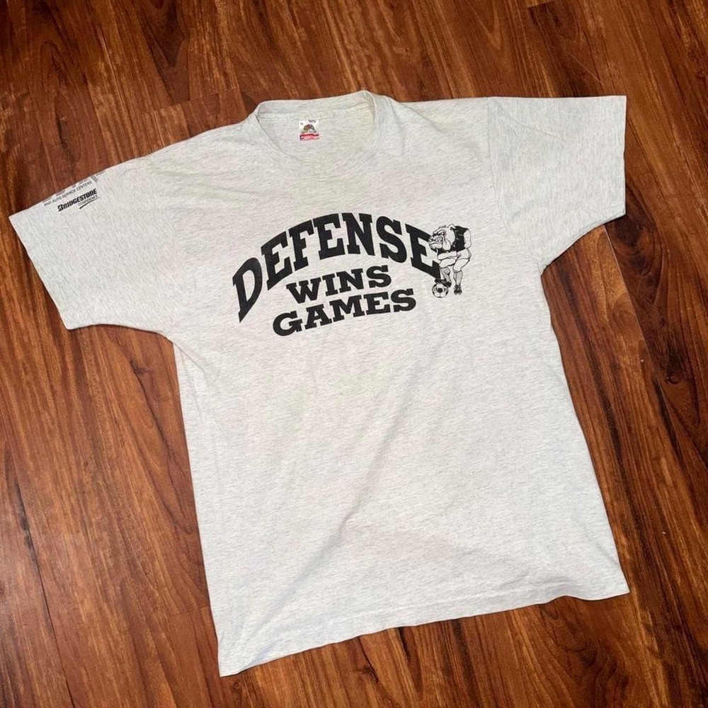 Gray vintage 90s "defense wins games" football tee